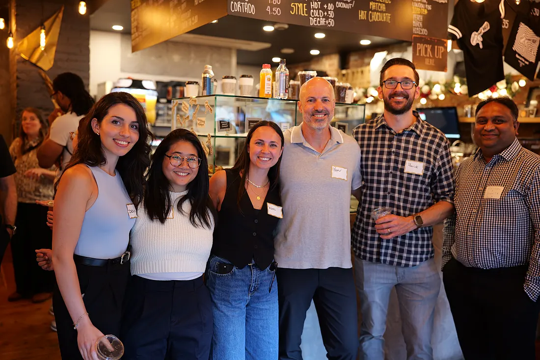 A group of attendees together at the end of an event